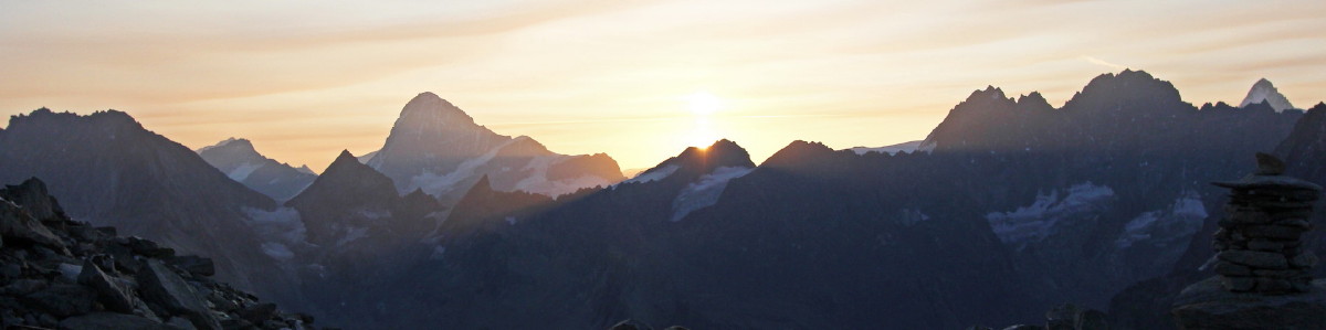 Photo of sunrise over the hills east of Arolla. The Dent Blanche centre left in the distance