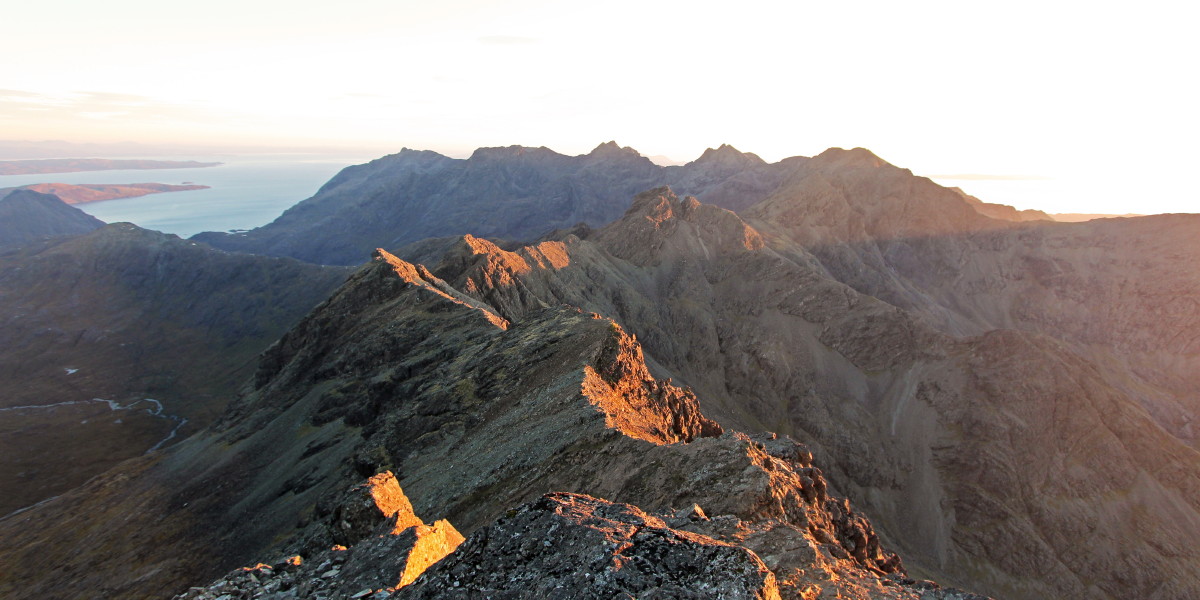 Photo of evening slanting sun light streaming across the Black Cuillin ridge south of Bruach na Frithe.