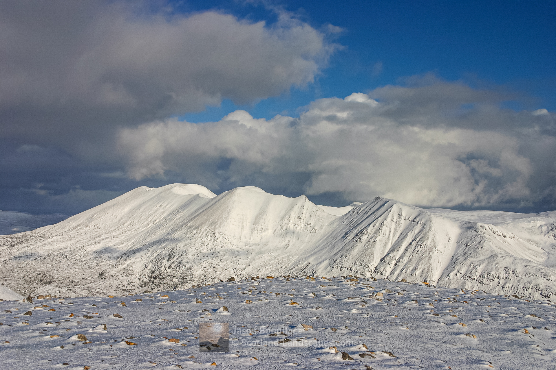 Photo of Foinaven wreathed in January snow, from the summit of Arkle