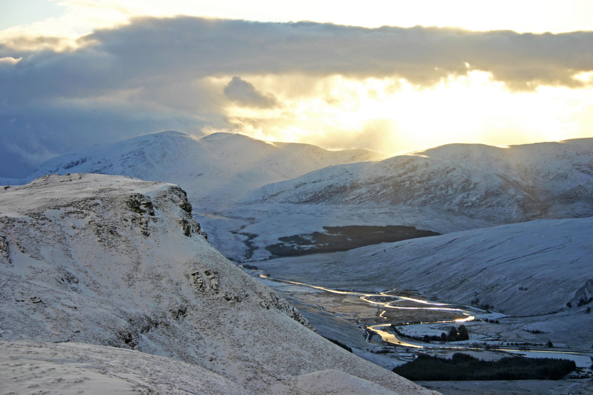 Photo of a snowy December view south down wild, remote Strath More to Ben Hee from the slopes of Ben Hope