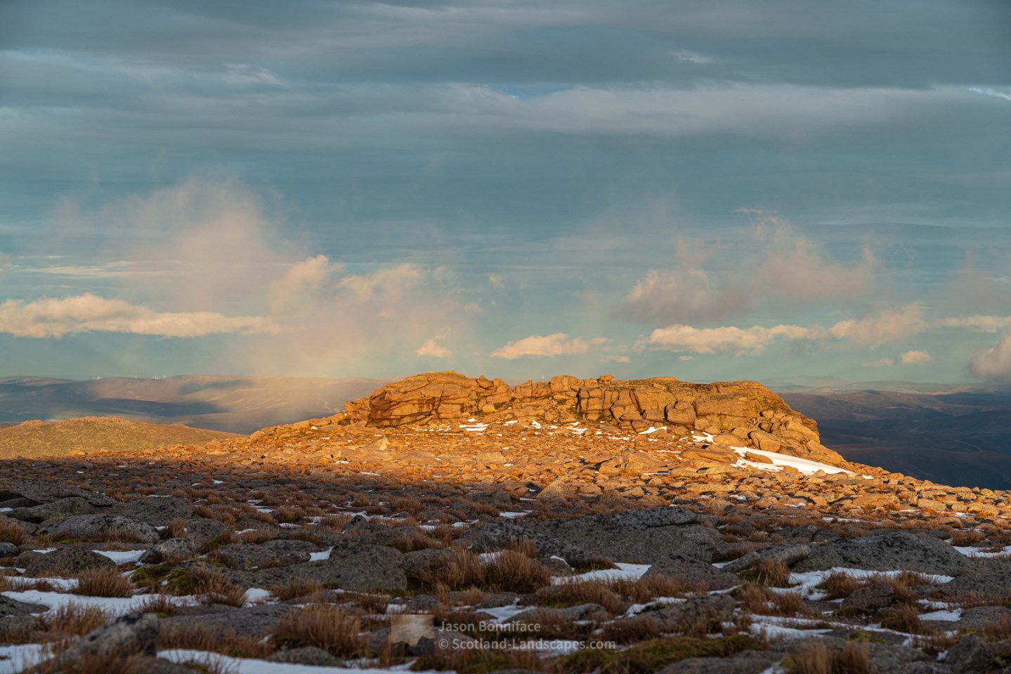 Photo of late sunlight shines on the granite tor just east of the summit of Cairngorm