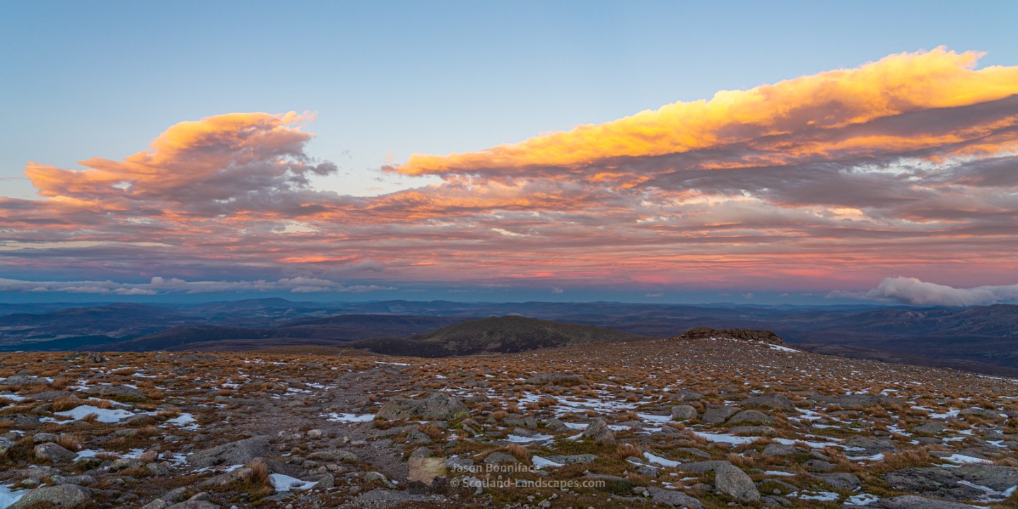 Photo of an easterly view from the summit of Cairngorm with clouds highlighted by the setting sun