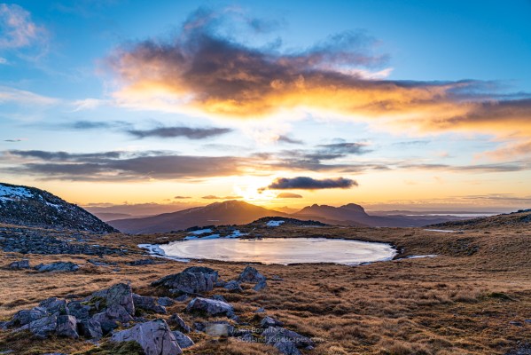 An afternoon glow as the sun descends behind Canisp, Stac Pollaidh and Suilven