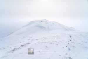 Looking south west along the summit ridge of Beinn Iaruinn in fresh February snow, Fort William and Glencoe