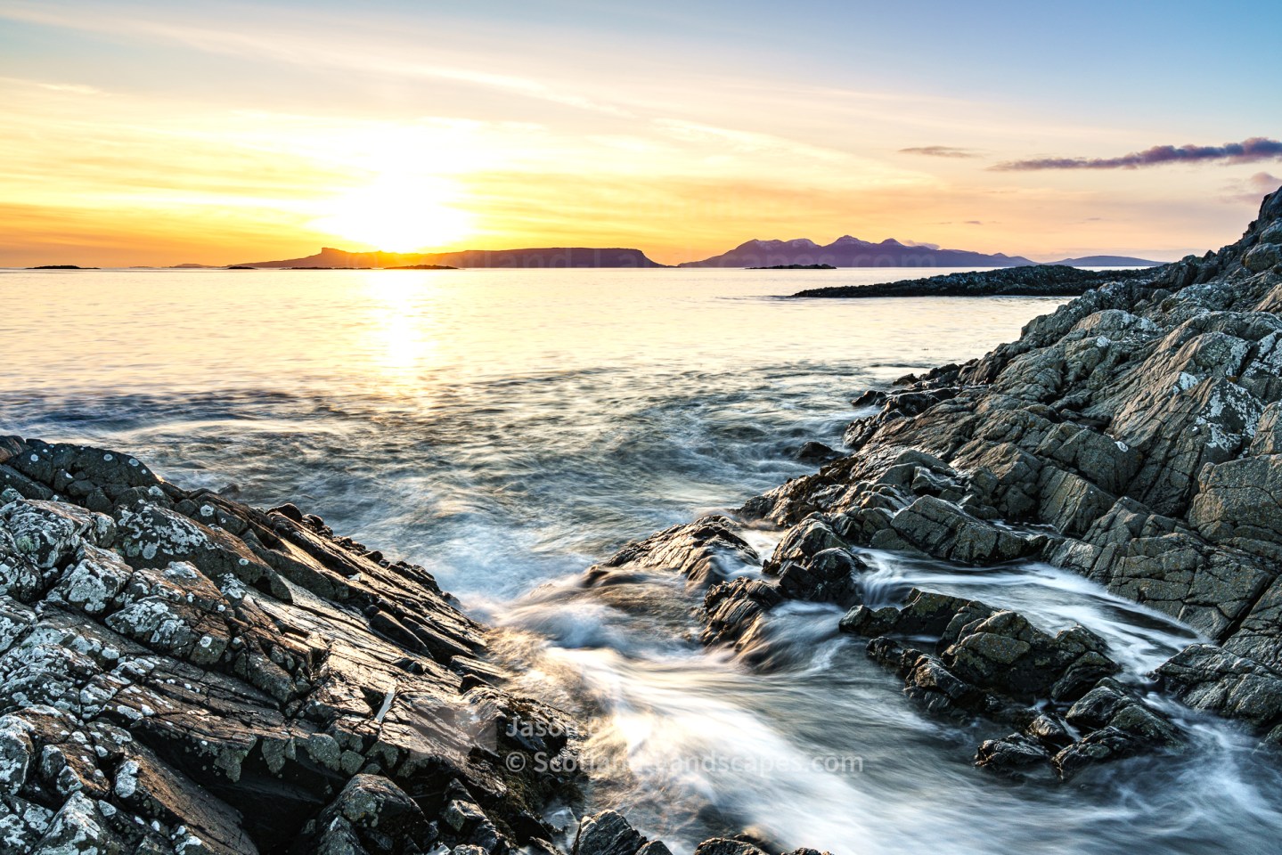 Sunset over the island of Eigg from the rocks at Camusdarach near Morar, Morar to Morvern